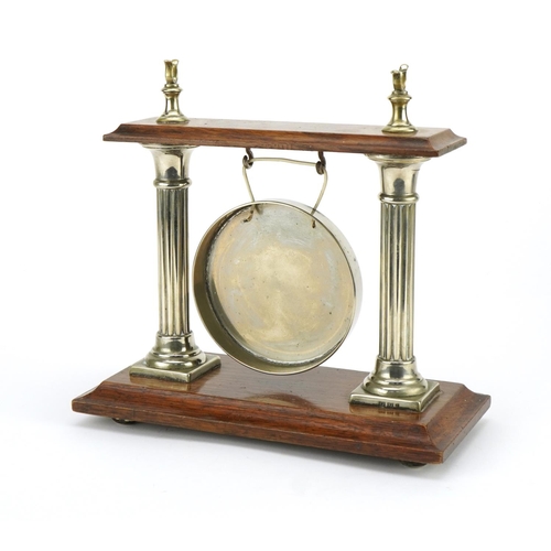 1268 - Silver plated and oak table gong with column supports, 24cm wide