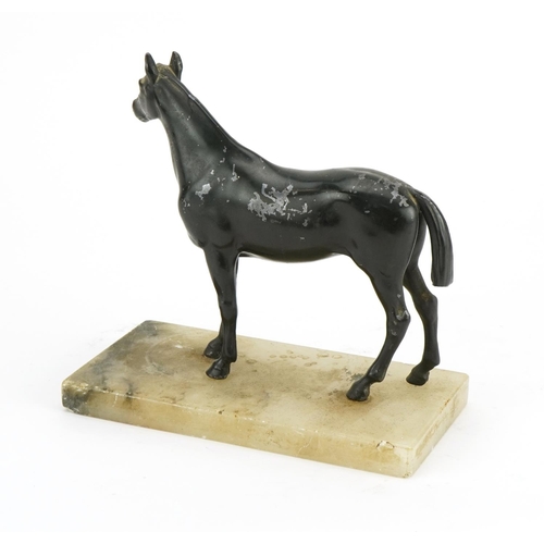 312 - Painted spelter study of a horse raised on a rectangular onyx base, 20cm in length