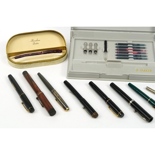 290 - Vintage and later fountain pens including a Burnham red marbleised with gold nib and box, brown ripp... 