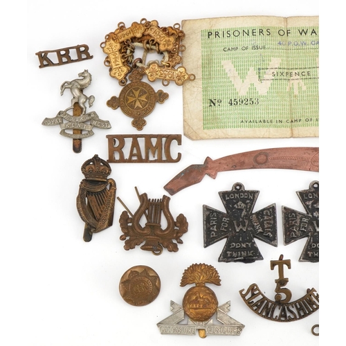 661 - British militaria including shoulder titles, cap badges and World War II Defence medal