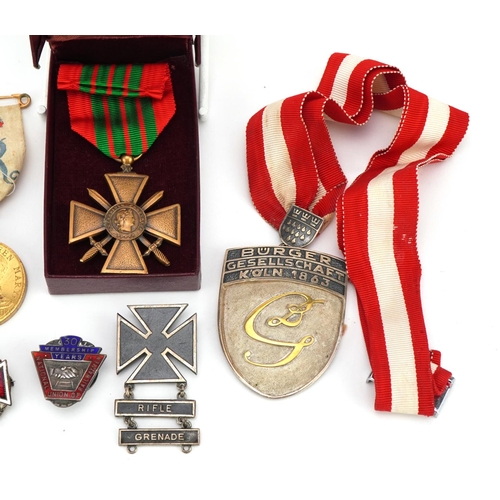 674 - British and foreign militaria and commemorative collectables including sterling silver Rifle & Grena... 