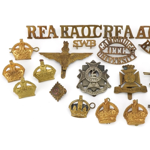 664 - Military interest cap badges and shoulder titles including Royal Berkshire, Bedfordshire & Herfordsh... 