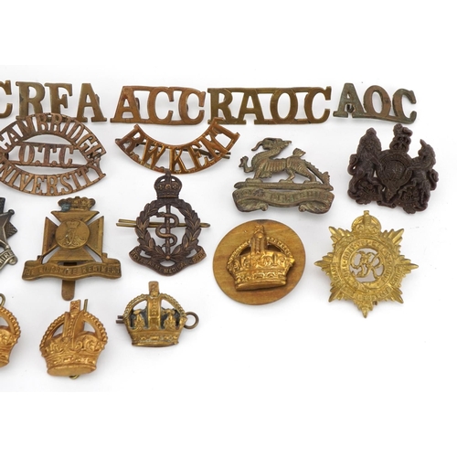 664 - Military interest cap badges and shoulder titles including Royal Berkshire, Bedfordshire & Herfordsh... 