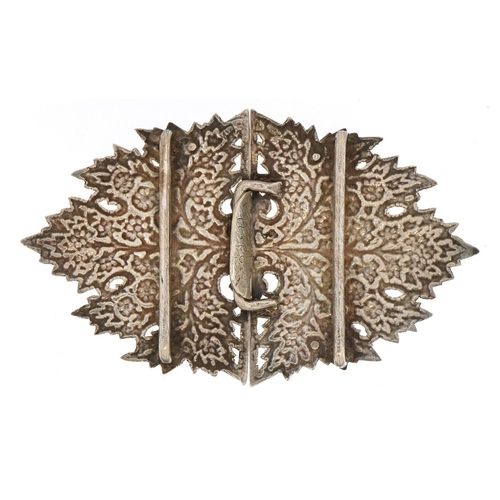 2740 - Unmarked silver two piece belt buckle embossed with blossoming trees, 11cm wide, 53.8g