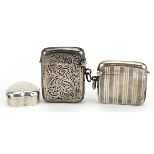 2741 - Two rectangular silver vestas with engraved and engine turned decoration together with a love heart ... 