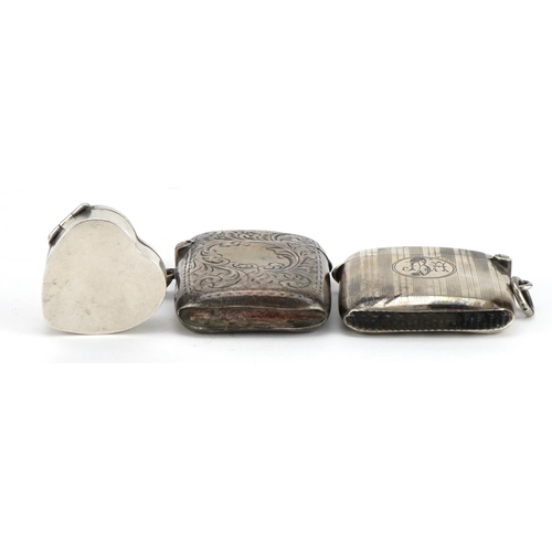 2741 - Two rectangular silver vestas with engraved and engine turned decoration together with a love heart ... 