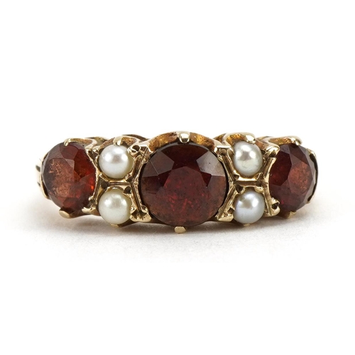 2070 - Victorian style 9ct gold garnet and seed pearl ring, the largest garnet approximately 6.0mm in diame... 