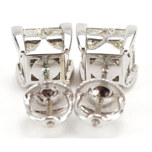 2005 - Pair of 18ct white gold Princess cut diamond earrings with screw backs housed in a tooled leather bo... 