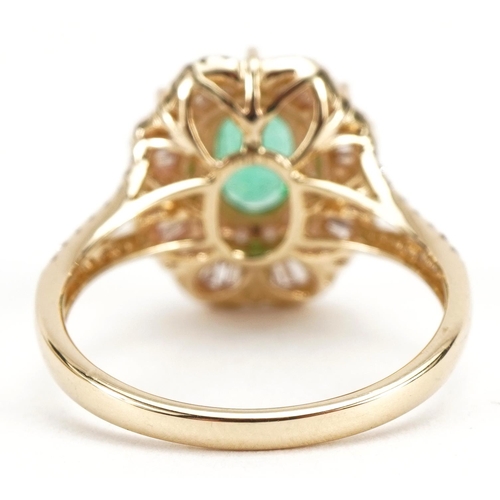 2059 - 14ct gold emerald and diamond cluster ring with diamond set split shoulders, total emerald weight ap... 