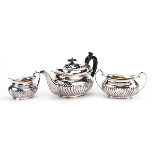 2698 - Victorian silver three piece tea service, the teapot with wooden handle and knop, G H maker's mark L... 