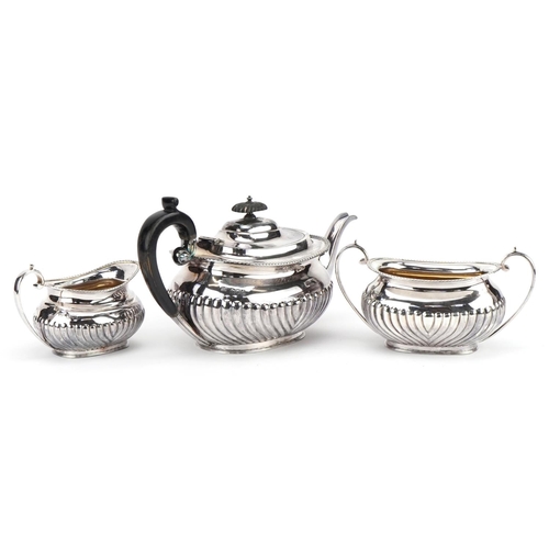 2698 - Victorian silver three piece tea service, the teapot with wooden handle and knop, G H maker's mark L... 