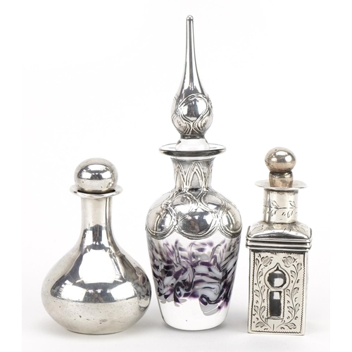 2743 - Three silver overlaid glass scent bottles with stoppers, the largest 13cm high