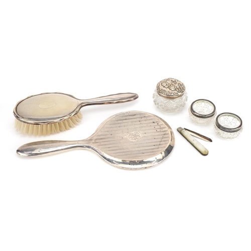 2764 - Silver mounted objects including a mother of pearl folding fruit knife, cut glass salts and a dressi... 