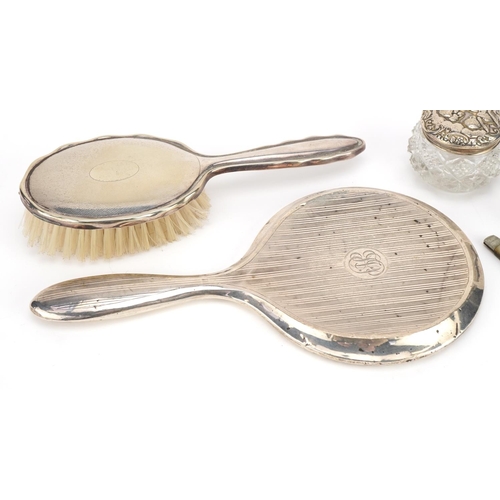 2764 - Silver mounted objects including a mother of pearl folding fruit knife, cut glass salts and a dressi... 