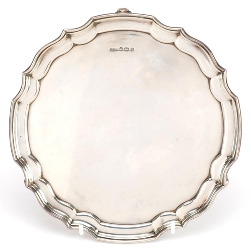 2720 - Harrison Fisher & Co, Elizabeth II circular silver salver raised on three scrolled feet, Sheffield 1... 