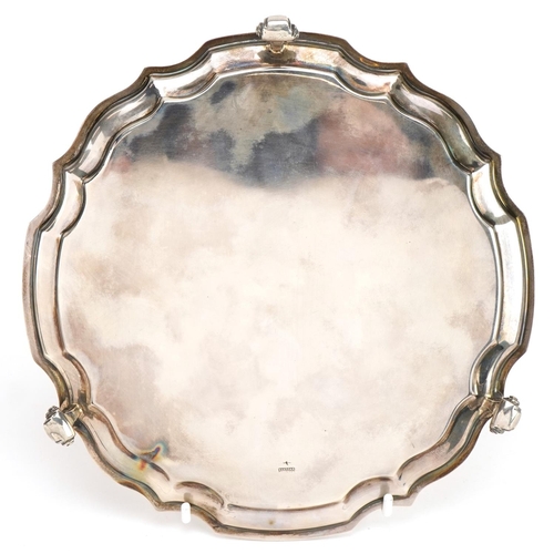 2720 - Harrison Fisher & Co, Elizabeth II circular silver salver raised on three scrolled feet, Sheffield 1... 