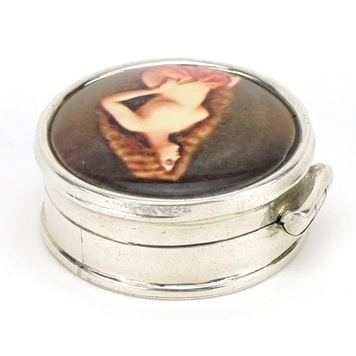 2747 - Circular silver and enamelled pillbox with hinged lid decorated with a semi nude female, 2.7cm in di... 