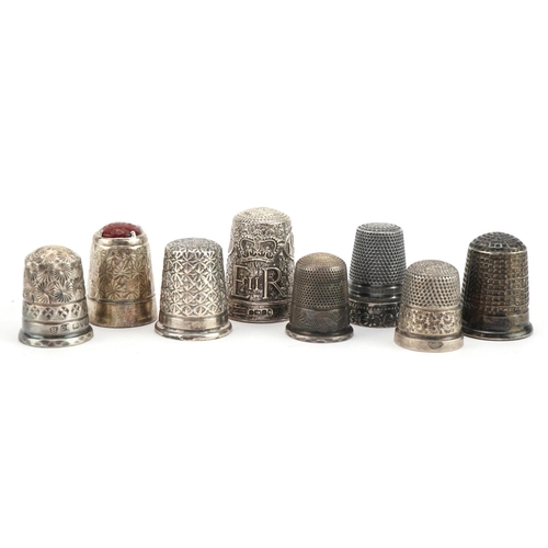 2752 - Eight silver thimbles including Elizabeth II Silver Jubilee and one with inset orange stone, the lar... 