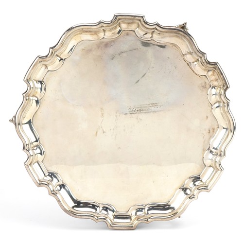 2714 - Martin Hall & Co Ltd, George V circular silver salver raised on three scrolled feet, Sheffield 1922,... 