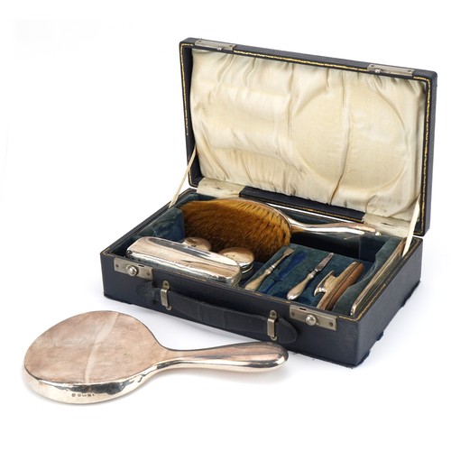 2715 - William Neale, George V silver travelling vanity set housed in a velvet and silk lined fitted case, ... 