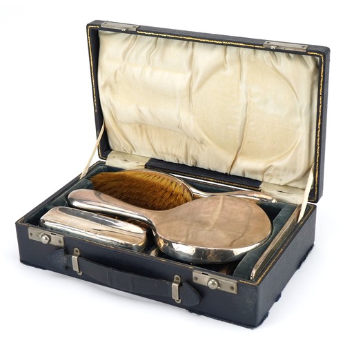 2715 - William Neale, George V silver travelling vanity set housed in a velvet and silk lined fitted case, ... 