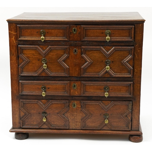 1045 - Jacobean style oak four drawer chest with brass handles and bun feet, 81cm H x 87cm W x 54cm D