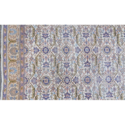 1016 - Rectangular Persian rug having an allover floral design within corresponding borders, 345cm x 255cm