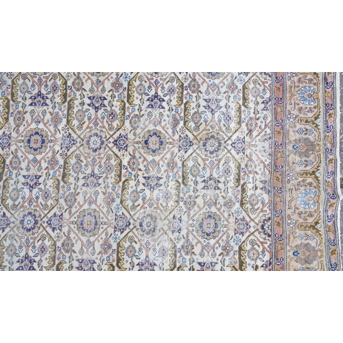 1016 - Rectangular Persian rug having an allover floral design within corresponding borders, 345cm x 255cm