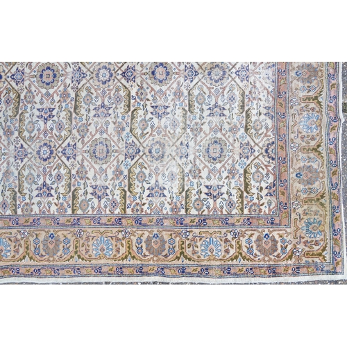 1016 - Rectangular Persian rug having an allover floral design within corresponding borders, 345cm x 255cm