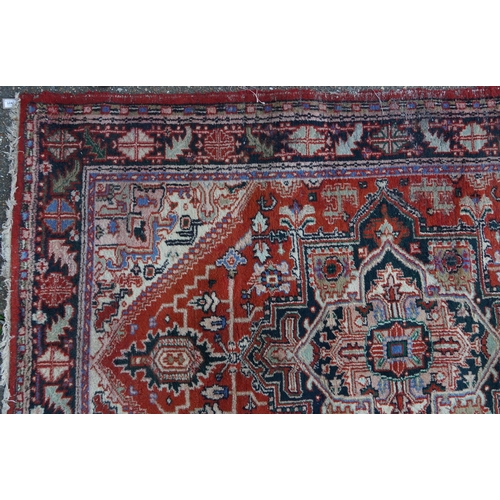 1041 - Rectangular Persian rug having an allover floral design onto a predominantly red ground, 240cm x 175... 