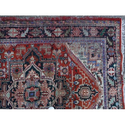 1041 - Rectangular Persian rug having an allover floral design onto a predominantly red ground, 240cm x 175... 