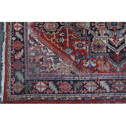 1041 - Rectangular Persian rug having an allover floral design onto a predominantly red ground, 240cm x 175... 