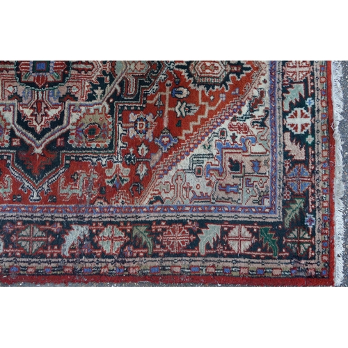 1041 - Rectangular Persian rug having an allover floral design onto a predominantly red ground, 240cm x 175... 