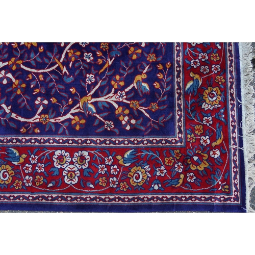 1046 - Rectangular Sarook Kashan silk rug decorated with birds amongst flowers onto a predominantly red and... 