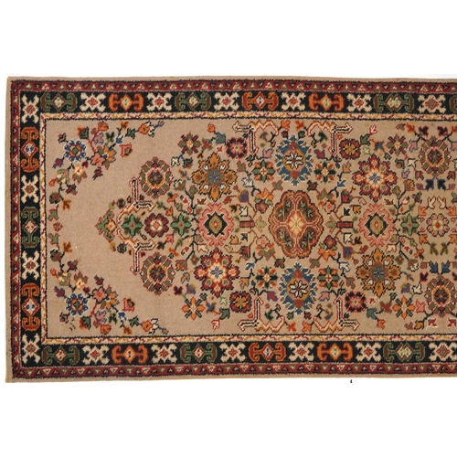 1055 - Rectangular floral carpet runner the central field having a beige ground, 270cm x 90cm