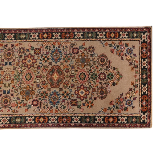 1055 - Rectangular floral carpet runner the central field having a beige ground, 270cm x 90cm