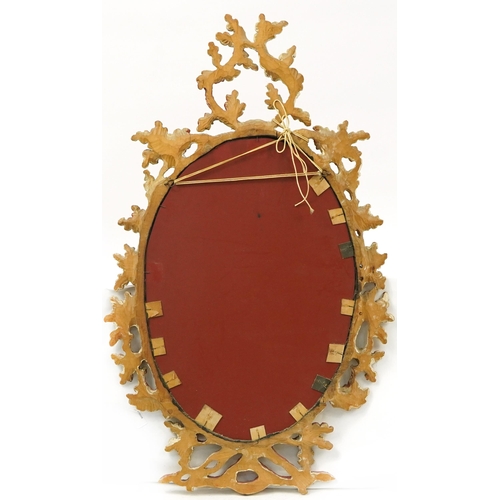 1060 - Oval giltwood framed wall hanging mirror with swag design, 92cm x 54cm