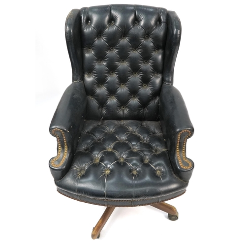 1061 - Mahogany framed captain's chair with black leather button upholstery, 109cm high