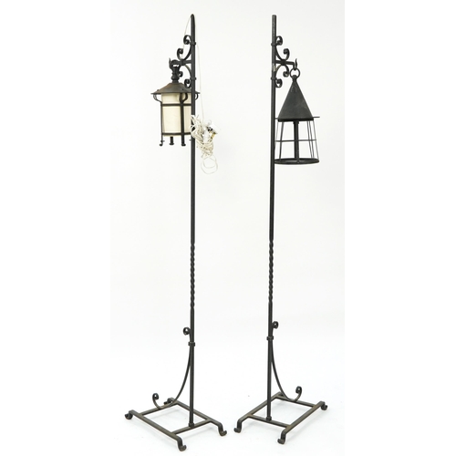 1067 - Pair of Arts and Crafts style black painted wrought iron floor standing lamps, 167cm high