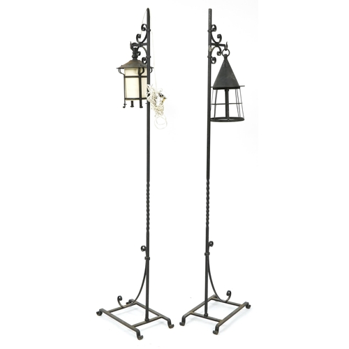 1067 - Pair of Arts and Crafts style black painted wrought iron floor standing lamps, 167cm high