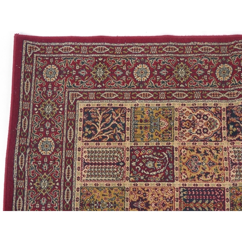 1080 - Rectangular Persian rug, the central field having a repeat tree design, the red ground borders havin... 