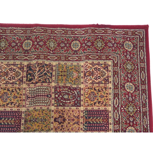 1080 - Rectangular Persian rug, the central field having a repeat tree design, the red ground borders havin... 