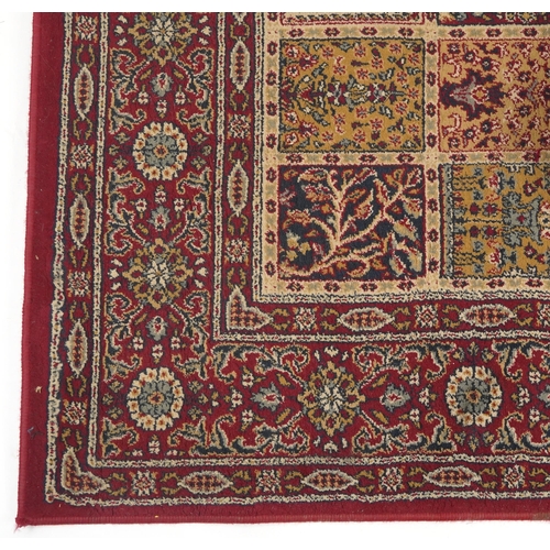 1080 - Rectangular Persian rug, the central field having a repeat tree design, the red ground borders havin... 