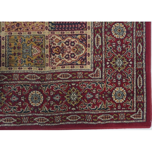 1080 - Rectangular Persian rug, the central field having a repeat tree design, the red ground borders havin... 