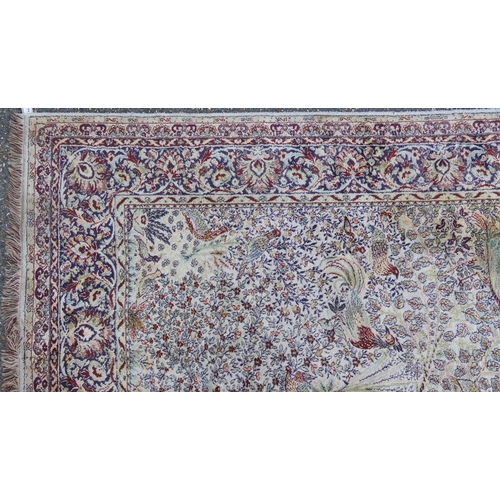 1084 - Rectangular Persian carpet, the central field decorated with birds of paradise amongst flowers withi... 