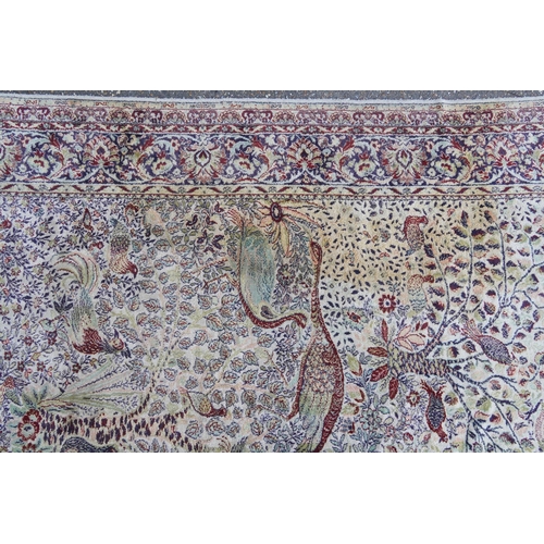 1084 - Rectangular Persian carpet, the central field decorated with birds of paradise amongst flowers withi... 