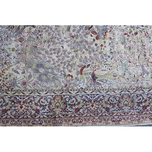 1084 - Rectangular Persian carpet, the central field decorated with birds of paradise amongst flowers withi... 