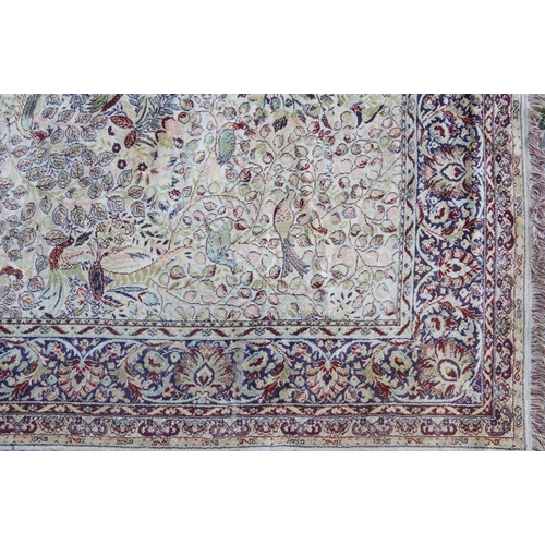 1084 - Rectangular Persian carpet, the central field decorated with birds of paradise amongst flowers withi... 