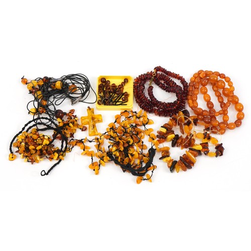 2647 - Five amber coloured necklaces, three bracelets and a cross pendant, total weight 196.0g