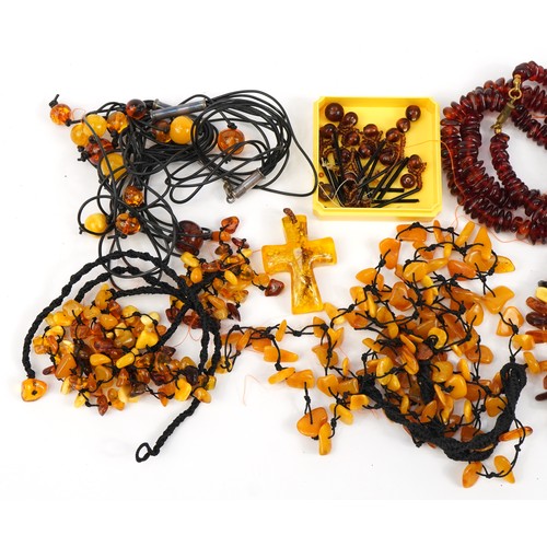 2647 - Five amber coloured necklaces, three bracelets and a cross pendant, total weight 196.0g